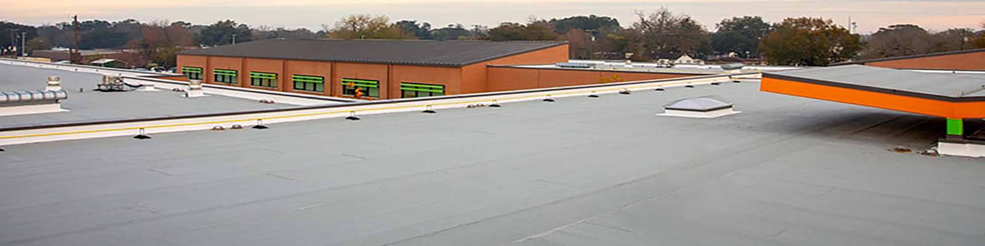 A metal roof on a building serviced by Garland Co, a commercial roofing company. 