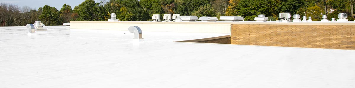 A white roof with cap sheet roofing applied by Garland.